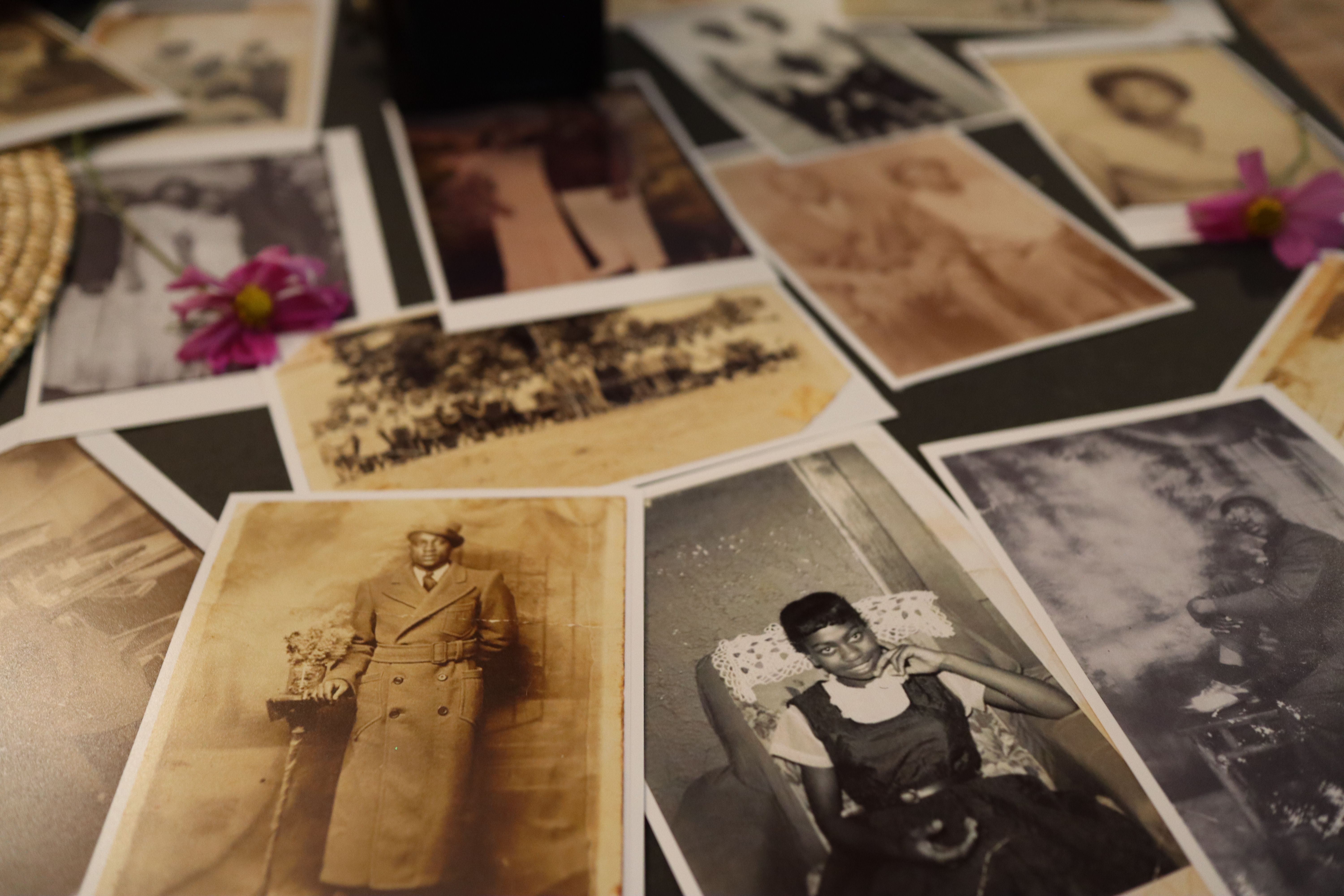 A collection of historical Black family photographs arranged on a table